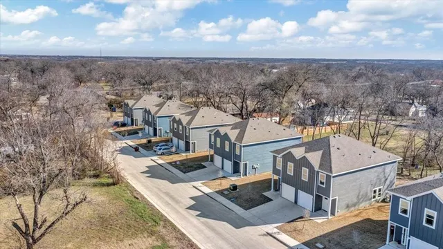 an aerial view of a house with a yard