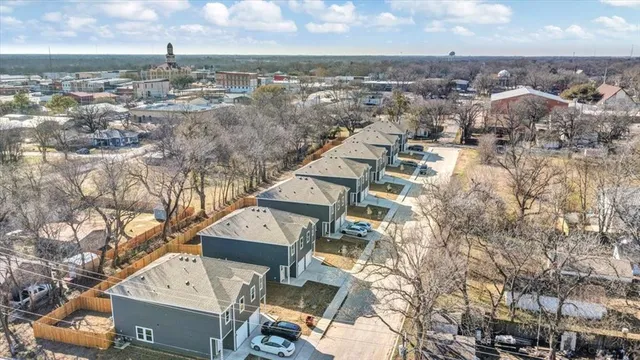 an aerial view of a residential apartment building with a yard