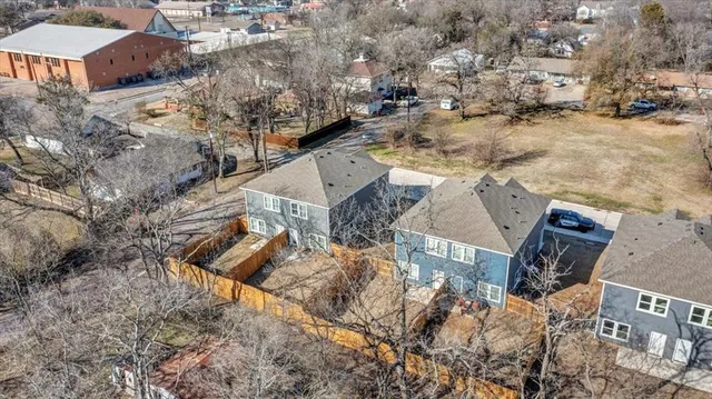 an aerial view of residential houses with outdoor space