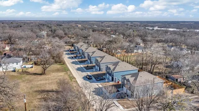 an aerial view of a house with a yard