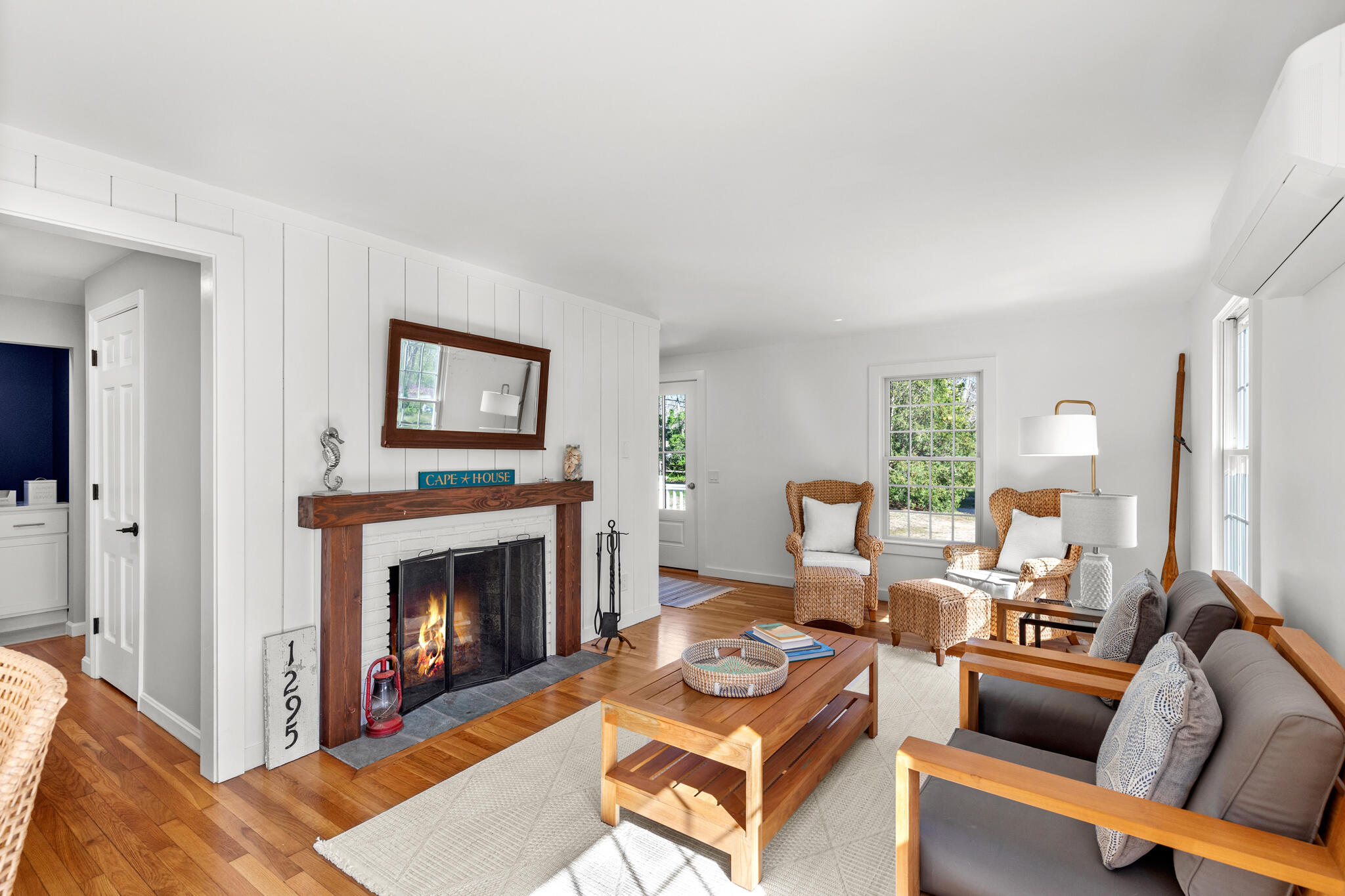 1295 Massasoit Road Eastham, MA 02642 - Photo 17 of 32 a living room with furniture a rug and a fireplace