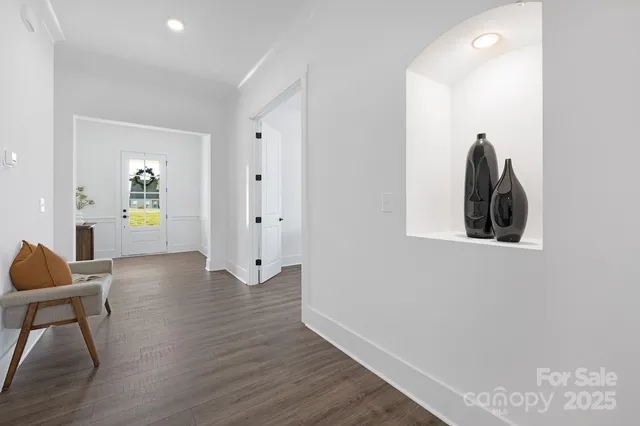 a living room with furniture a table and wooden floor
