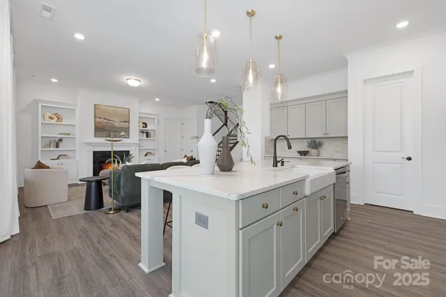 a kitchen with stainless steel appliances granite countertop a lot of counter space and wooden floors