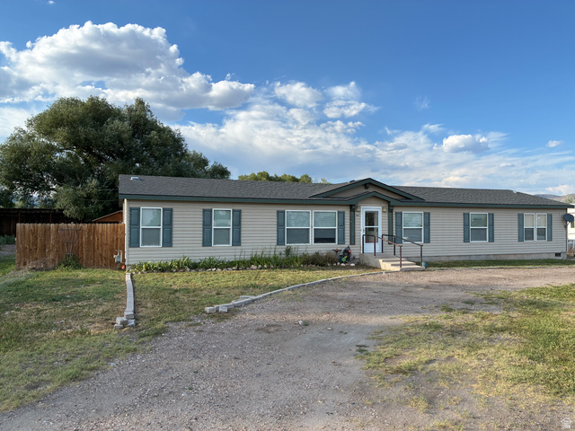 547 East 2000th Street North Vernal, UT 84078 - Photo 1 of 50 Single-story home featuring light-colored siding, a dark shingle roof, and contrasting blue window shutters