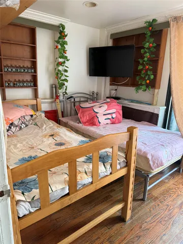 a bedroom with a bed and flat screen tv