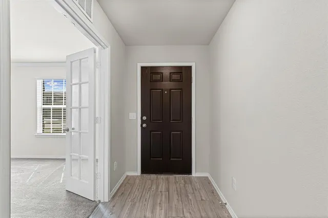 an empty room with windows and closet