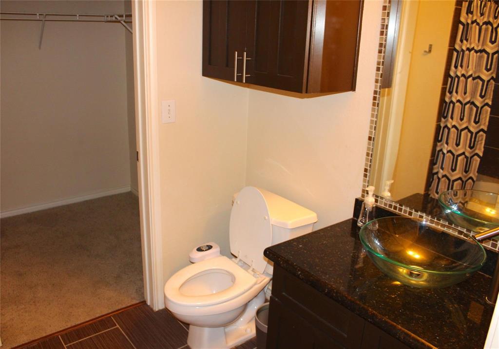 3102 Kings Road, Unit 1207 Dallas, TX 75219 - Photo 11 of 13 a bathroom with a sink and a mirror