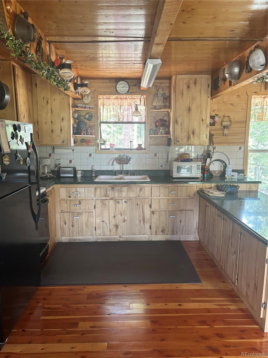 1113 Spring Street Del Norte, CO 81132 - Photo 22 of 45 a view of a kitchen with kitchen island granite countertop a sink and a stove