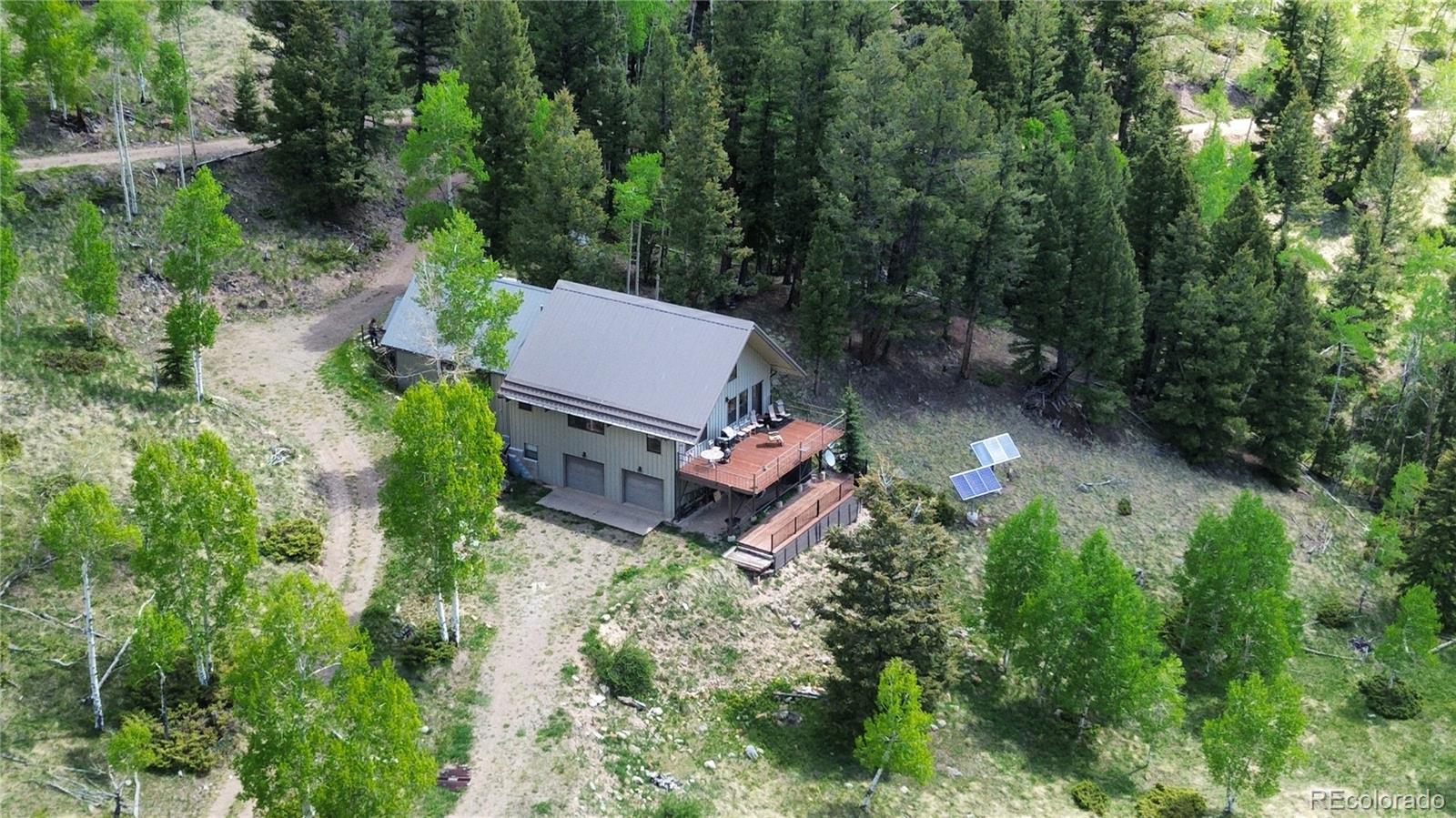 1113 Spring Street Del Norte, CO 81132 - Photo 3 of 45 an aerial view of a house with yard and outdoor seating