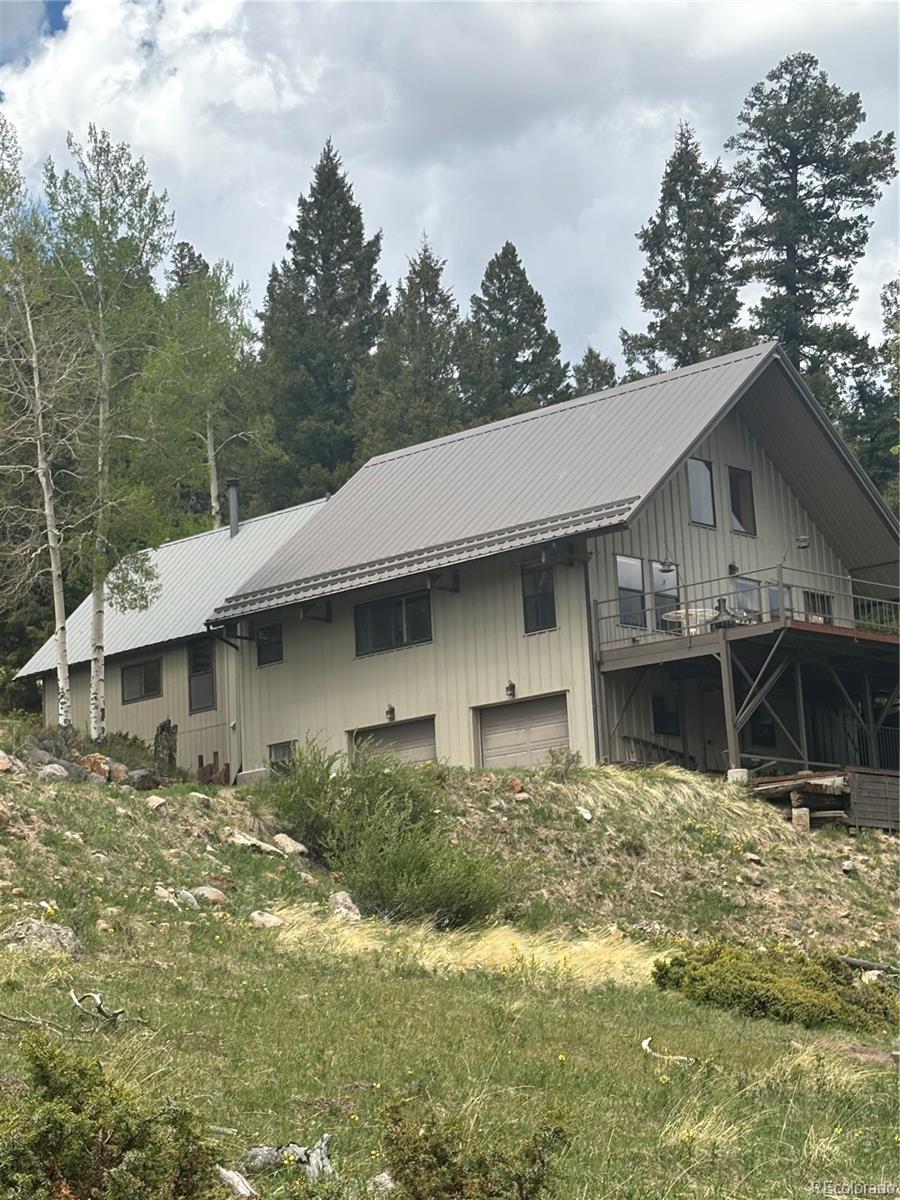 1113 Spring Street Del Norte, CO 81132 - Photo 6 of 45 a front view of a house with a yard