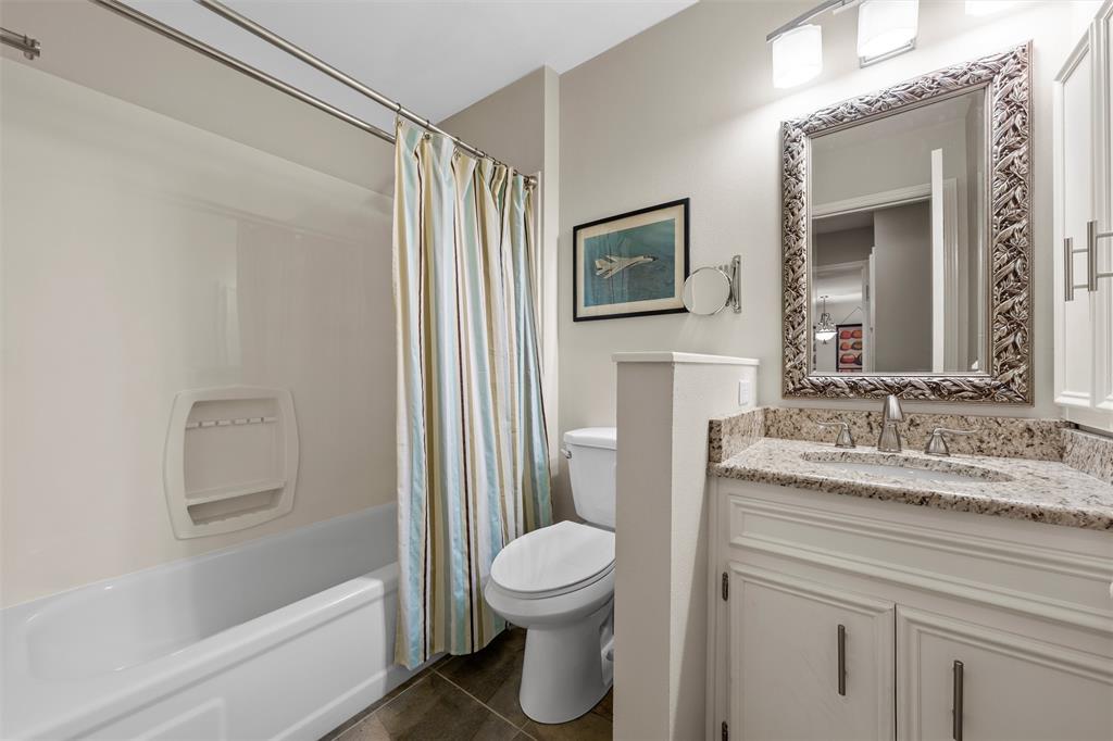 2901 Lake Shore Drive, Unit 405 Waco, TX 76708 - Photo 20 of 31 a bathroom with a granite countertop sink toilet a mirror and shower