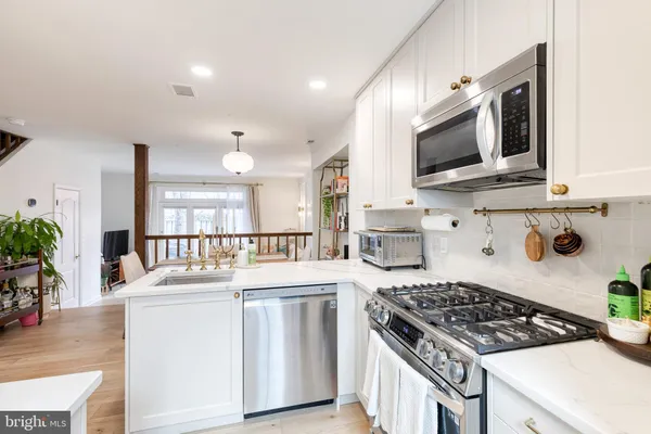 a kitchen that has a sink and a stove top oven