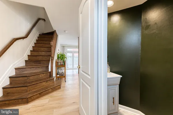 a view of entryway and hall with wooden floor