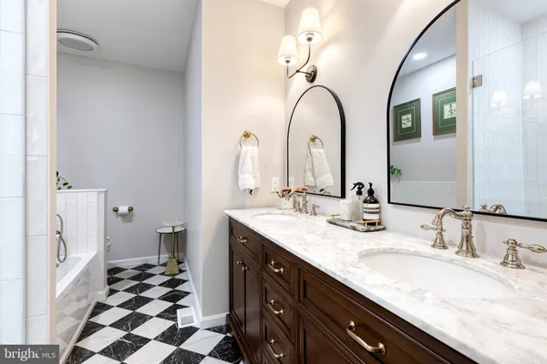 a bathroom with a granite countertop sink mirror and double