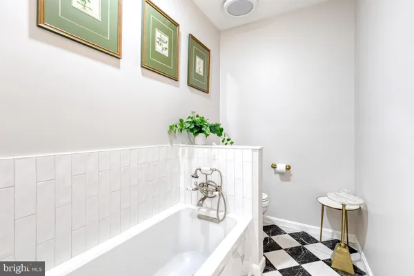 a bath tub sitting next to a white sink