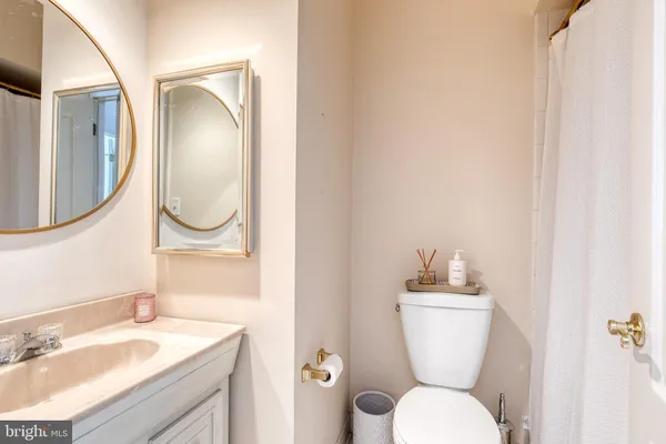 a bathroom with a toilet a sink and a mirror