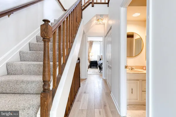 a view of entryway and hall with wooden floor