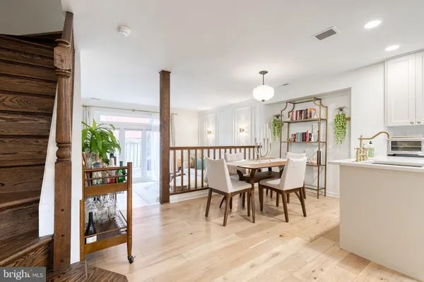 a dining room with furniture and wooden floor