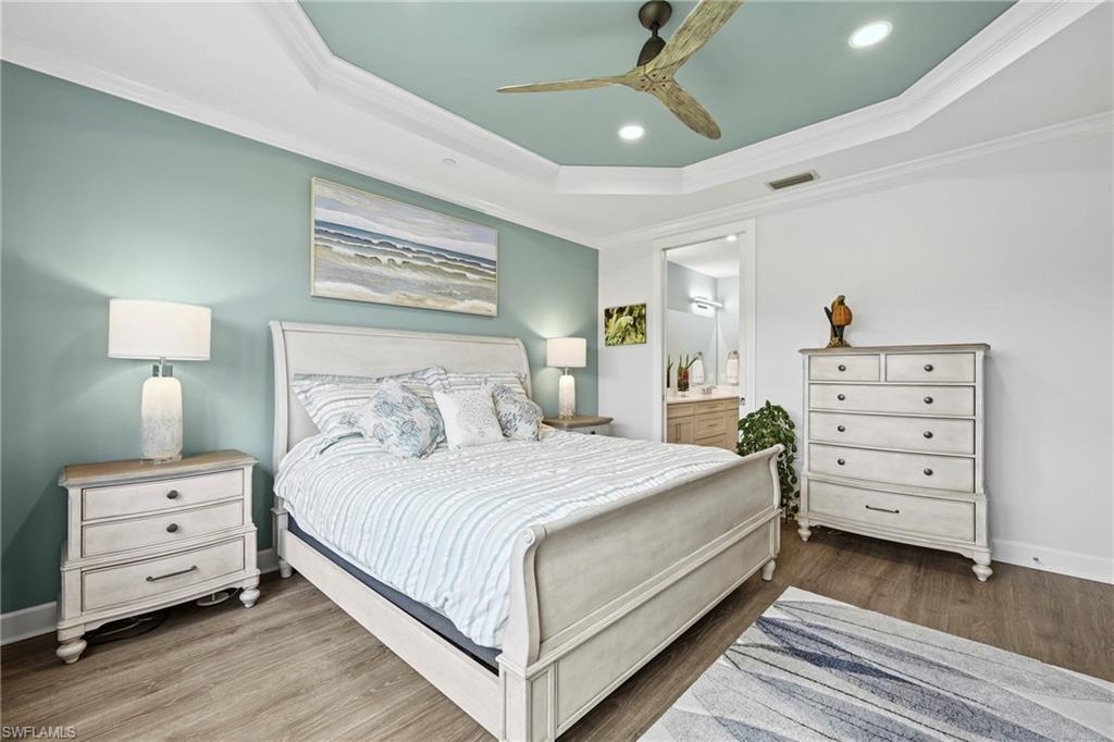 15245 Zeno Way, Unit 101 Naples, FL 34114 - Photo 16 of 46 a bedroom with a bed and a dresser