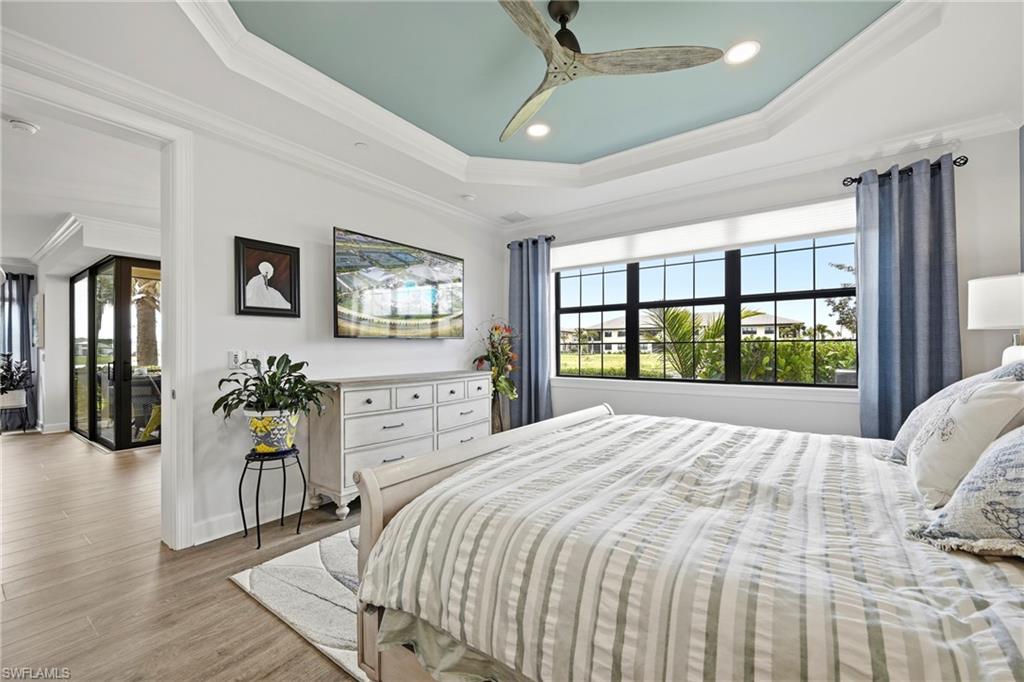 15245 Zeno Way, Unit 101 Naples, FL 34114 - Photo 17 of 46 a bedroom with a large bed and a large window