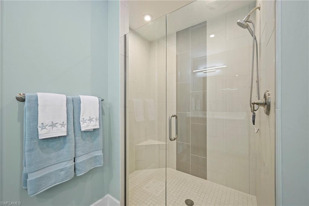 15245 Zeno Way, Unit 101 Naples, FL 34114 - Photo 19 of 46 a bathroom with a glass shower door