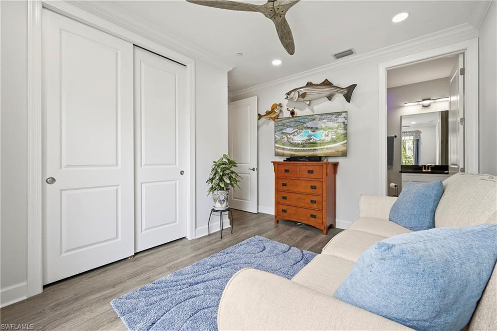 15245 Zeno Way, Unit 101 Naples, FL 34114 - Photo 23 of 46 a living room with furniture and wooden floor