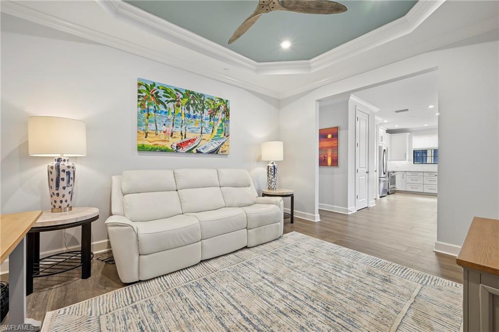 15245 Zeno Way, Unit 101 Naples, FL 34114 - Photo 26 of 46 a living room with furniture and a wooden floor