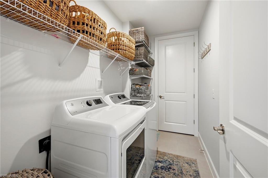 15245 Zeno Way, Unit 101 Naples, FL 34114 - Photo 28 of 46 a utility room with dryer and washer