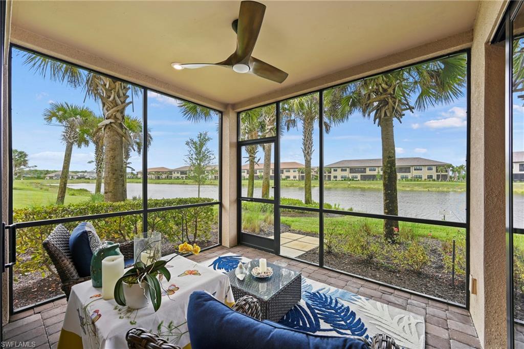 15245 Zeno Way, Unit 101 Naples, FL 34114 - Photo 29 of 46 a living room with furniture and floor to ceiling windows