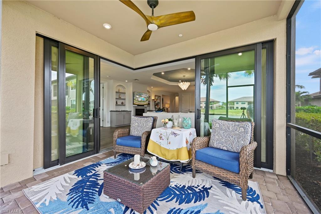 15245 Zeno Way, Unit 101 Naples, FL 34114 - Photo 30 of 46 a living room with furniture and a large window
