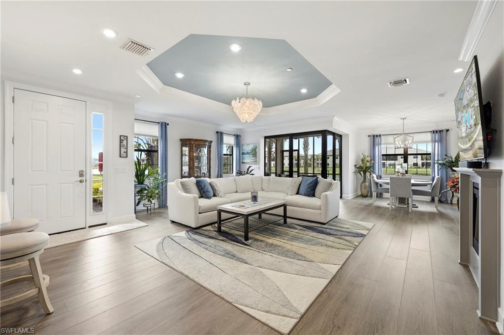15245 Zeno Way, Unit 101 Naples, FL 34114 - Photo 3 of 46 a living room with furniture and a wooden floor