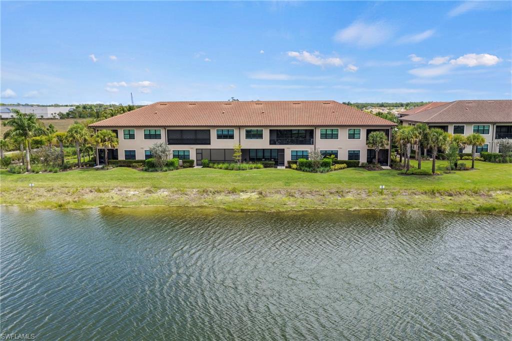 15245 Zeno Way, Unit 101 Naples, FL 34114 - Photo 32 of 46 a view of a house next to a big yard with large trees