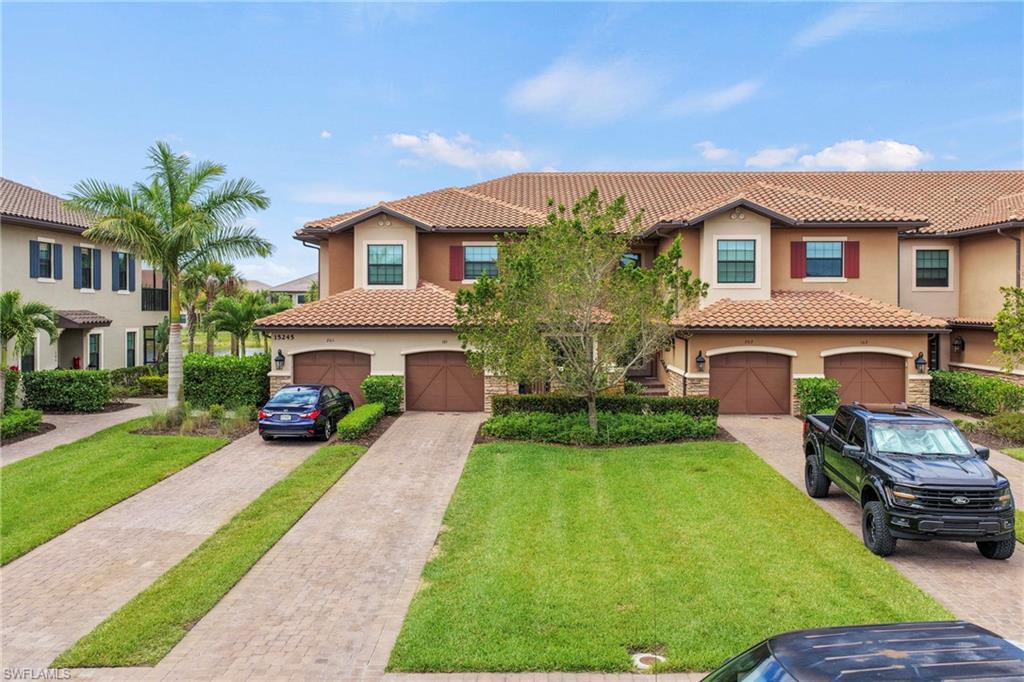 15245 Zeno Way, Unit 101 Naples, FL 34114 - Photo 33 of 46 a front view of a house with garden
