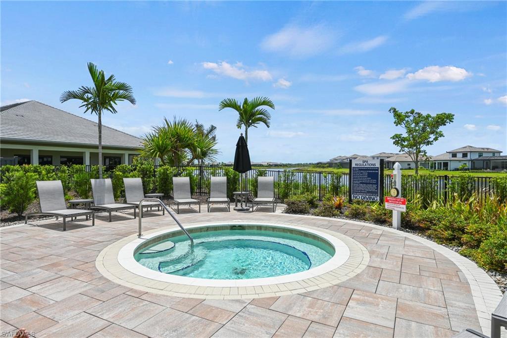15245 Zeno Way, Unit 101 Naples, FL 34114 - Photo 37 of 46 a swimming pool with outdoor seating yard and barbeque oven