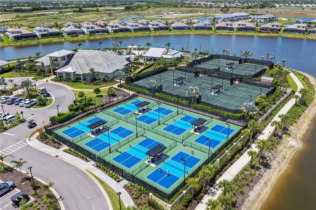 15245 Zeno Way, Unit 101 Naples, FL 34114 - Photo 38 of 46 an aerial view of a resort with swimming pool and outdoor seating