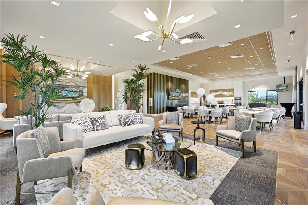 15245 Zeno Way, Unit 101 Naples, FL 34114 - Photo 41 of 46 a living room with lots of furniture and a large mirror