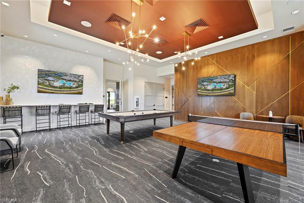 15245 Zeno Way, Unit 101 Naples, FL 34114 - Photo 42 of 46 a room with furniture pool table and paintings on the wall