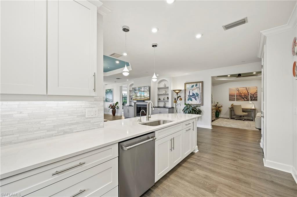 15245 Zeno Way, Unit 101 Naples, FL 34114 - Photo 10 of 46 a kitchen with a sink and cabinets