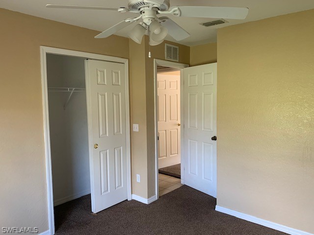 3206 51st Street West Lehigh Acres, FL 33971 - Photo 13 of 20 a view of a hallway with a chandelier fan