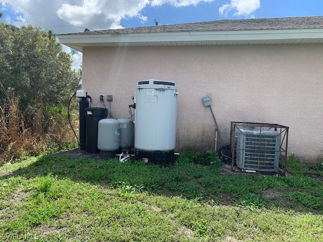 3206 51st Street West Lehigh Acres, FL 33971 - Photo 19 of 20 a backyard of a house with lots of green space and plants
