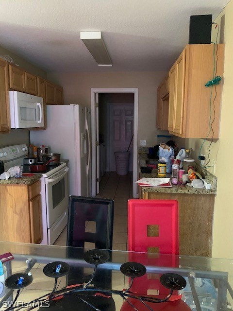 3206 51st Street West Lehigh Acres, FL 33971 - Photo 2 of 20 a kitchen with a sink stove and refrigerator