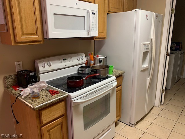 3206 51st Street West Lehigh Acres, FL 33971 - Photo 4 of 20 a kitchen with a stove and a refrigerator