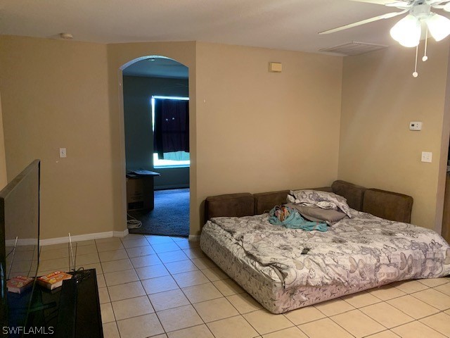 3206 51st Street West Lehigh Acres, FL 33971 - Photo 6 of 20 a bedroom with a bed and a mirror