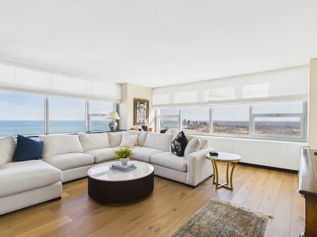 a view of a room with a large window and front door