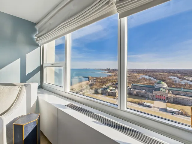 a bedroom with a bed and a lamp