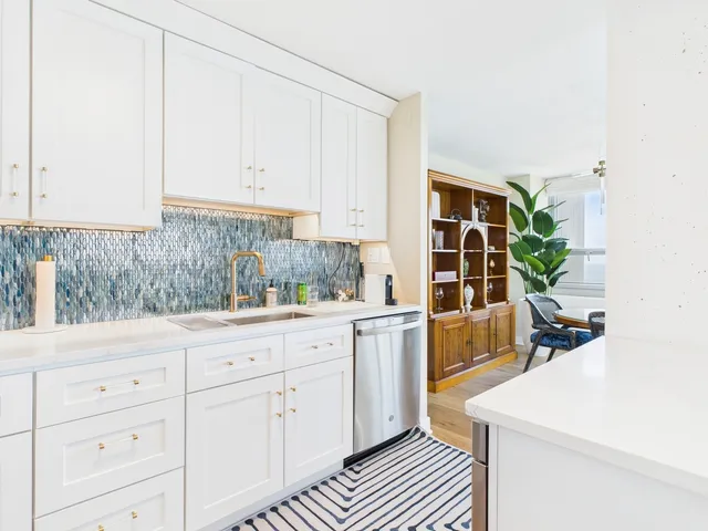 a kitchen with sink and cabinets