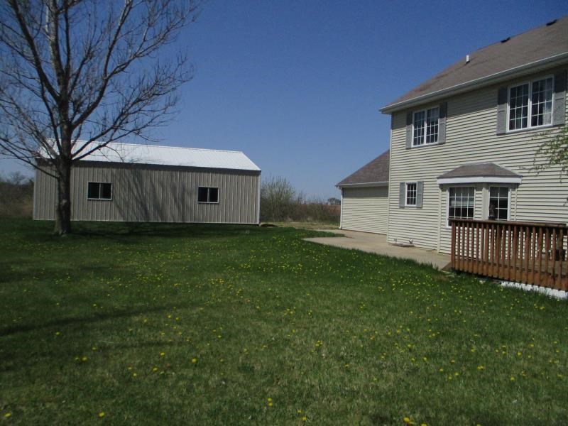 8405 North Boone School Road Capron, IL 61012 - Photo 4 of 25 a backyard of a house with lots of green space and mountain view