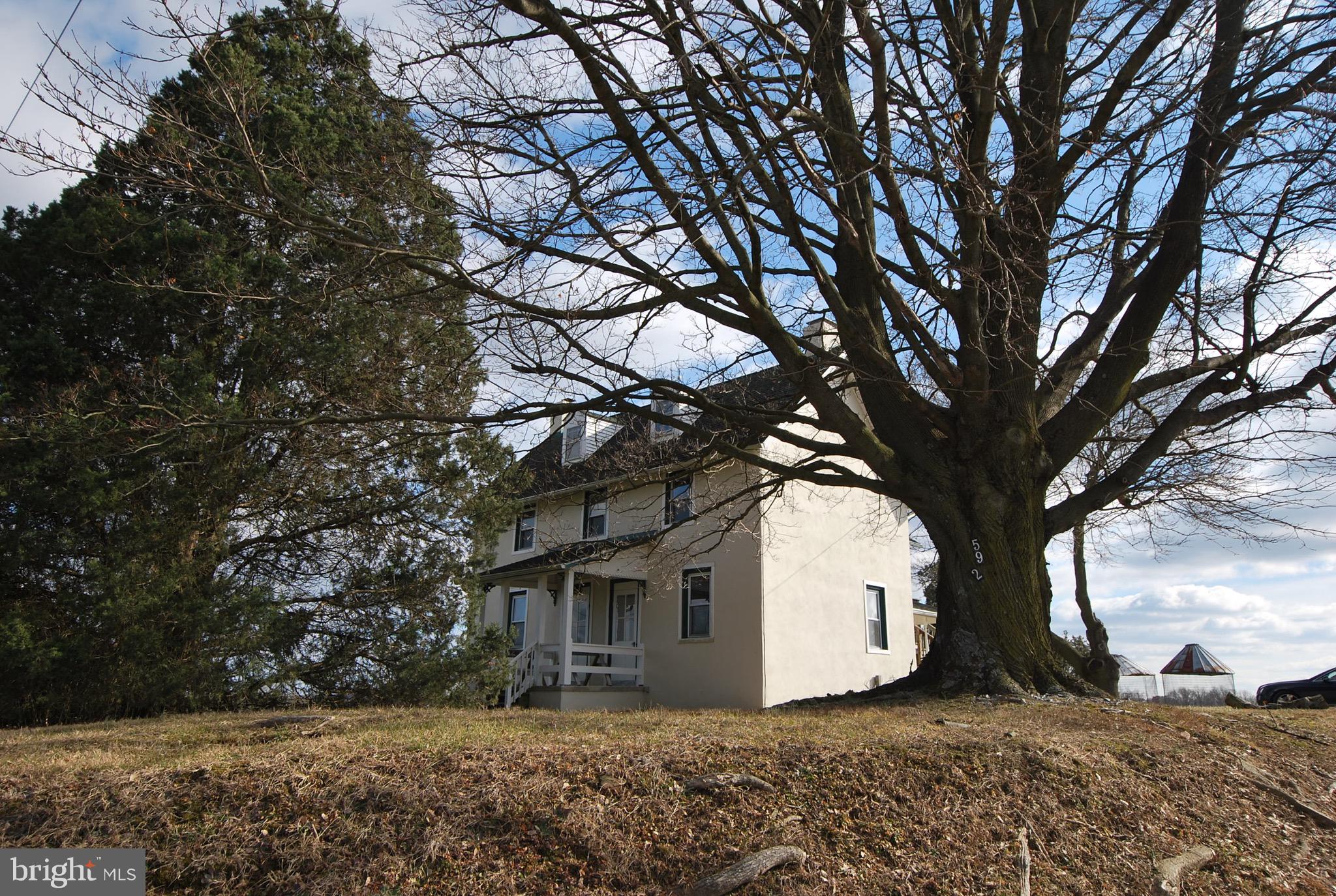 a view of house with a trees