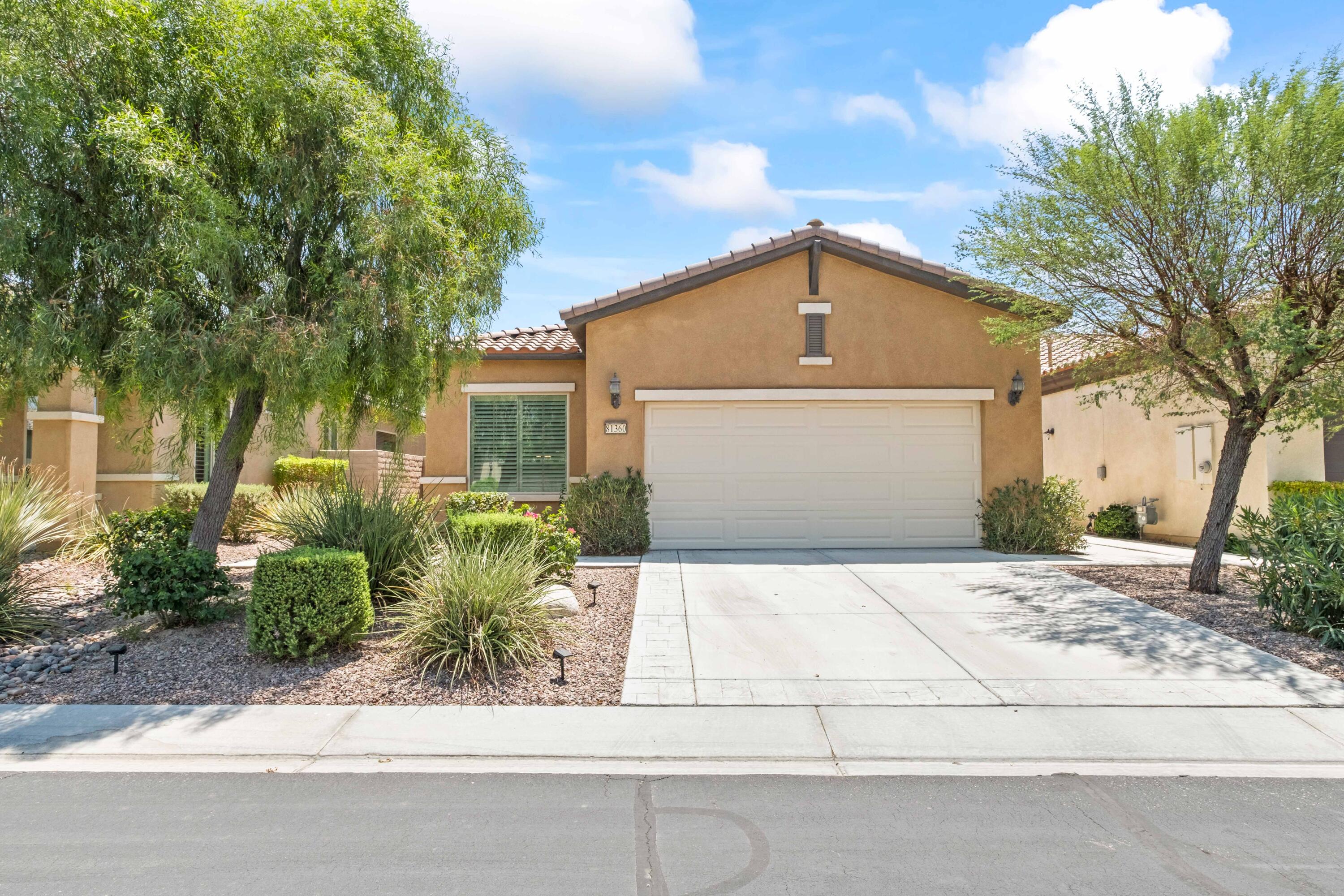 81360 Corte Compras Indio, CA 92203 - Photo 1 of 24 a front view of a house with a yard and garage