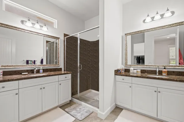 a bathroom with double sink and a mirror